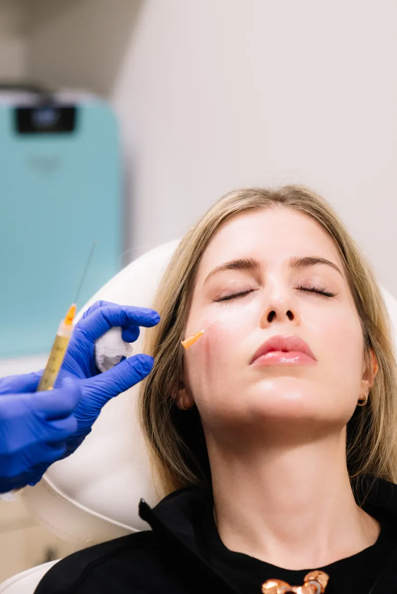 Provider giving a PRP injection along a patient's cheekbone